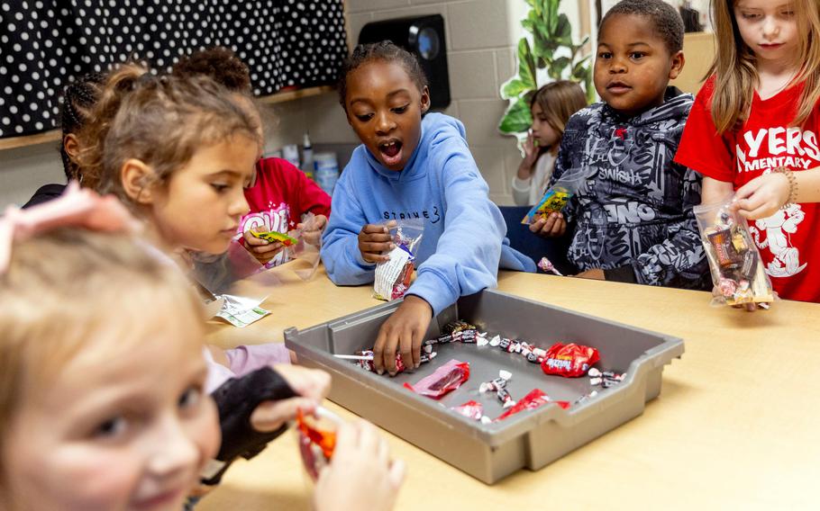 First and second grade students help fill bags of donated Halloween candy