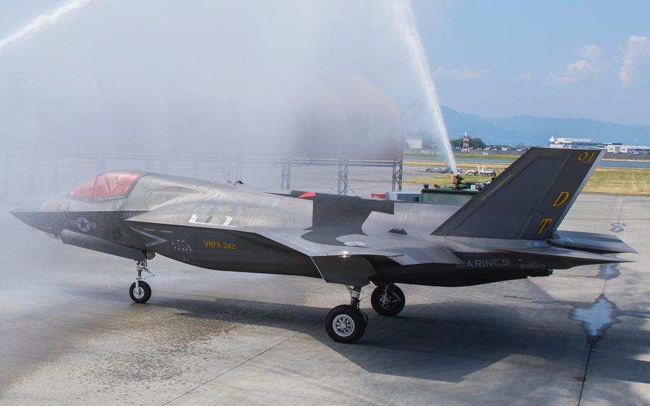 Marine  Lt. Col. Alexander Mellman of Marine Fighter Attack Squadron 242, is hosed down in an F-35B Lightning II aircraft after his final flight at Marine Corps Air Station Iwakuni, Japan, June 11, 2024.