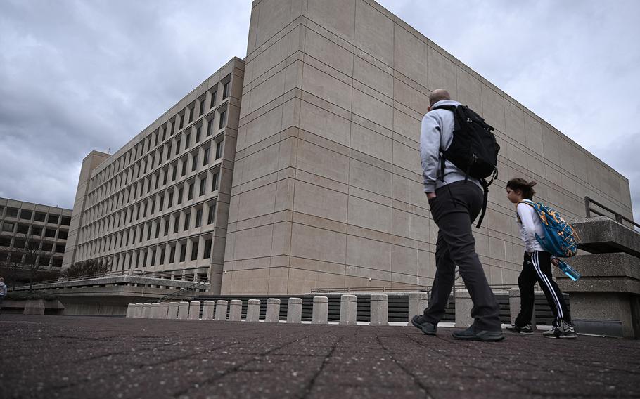 A large brutalist building takes up most of the space, while a plaza takes up the bottom quarter of the image.