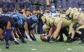 FILE - The Navy Midshipmen and the Army Black Knights line up for the snap at the line of scrimmage during the first quarter of an NCAA football game at Gillette Stadium, Dec. 9, 2023, in Foxborough, Mass. (AP Photo/Winslow Townson, file)