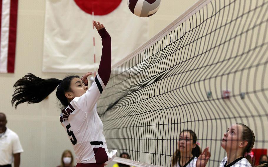 Matthew C. Perry's Haleigh Quinn tries to hit past E.J. King's Aileen Fitzgerald and Madylyn O'Neill during Friday's Japan volleyball match. The Cobras won in three sets.