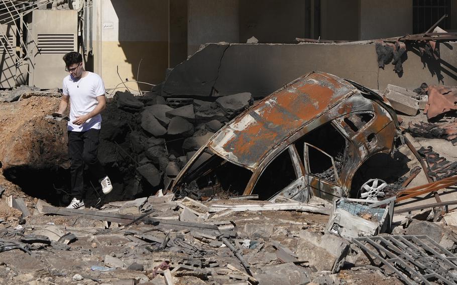 A man walks on rubble after an airstrike in a suburb of Beirut.