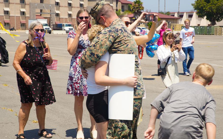 U.S. Marine Corps Maj. Robert Flahive, deputy staff judge advocate assigned to the 15th Marine Expeditionary Unit, embraces his daughter at a welcome home reception at Marine Corps Base Camp Pendleton, Calif., on Aug. 10, 2024. 