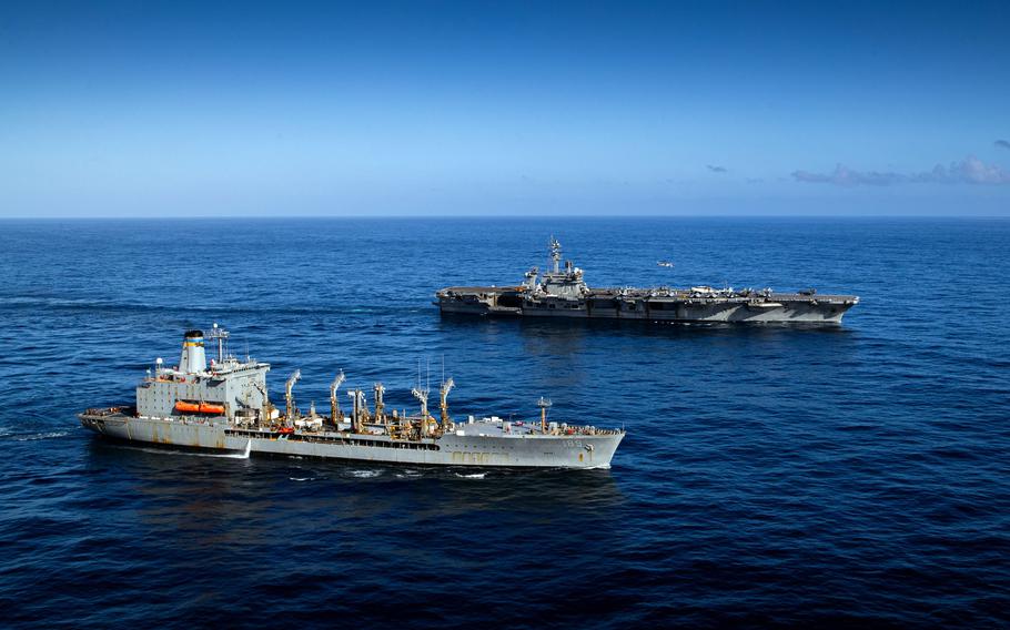 The aircraft carrier USS George Washington and fleet replenishment oiler USNS John Lenthall conduct a vertical replenishment in the Pacific Ocean on June 14, 2024.