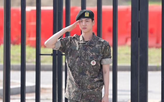 K-pop boy band BTS member Jin poses for photographs after being discharged from the military in Yeoncheon, South Korea, June 12, 2024.