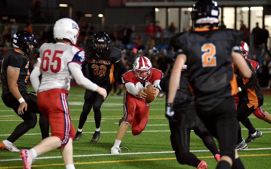 International School of Brussels quarterback Max Ball crosses the goal line in front of Spangdahlem defenders at the end of the first half of a game on September 21, 2024 at Spangdahlem High School in Spangdahlem, Germany.