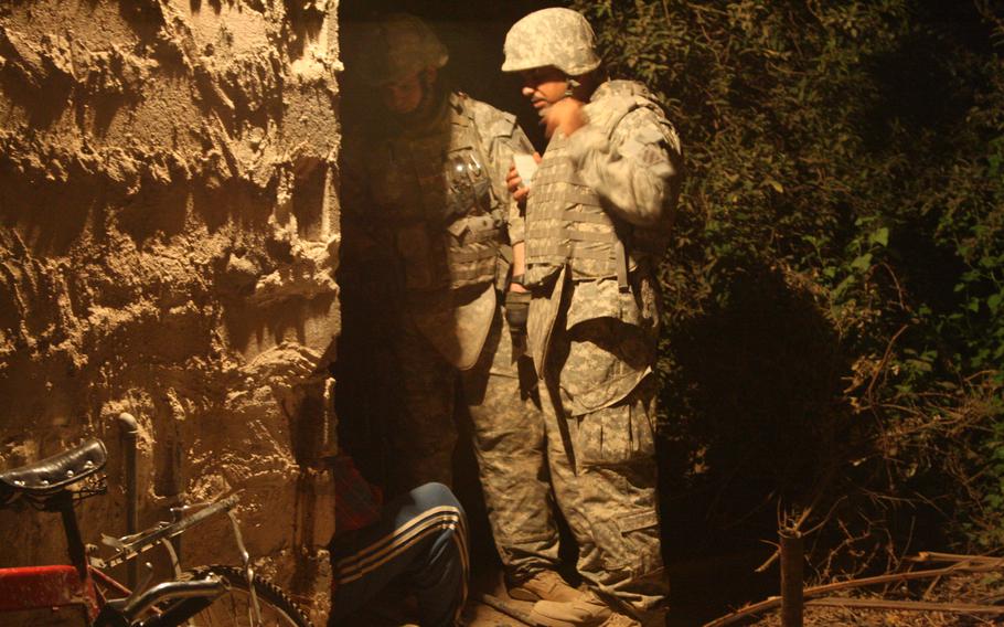 A U.S. soldier, left, and an Iraqi interpreter question a man suspected of helping insurgents direct mortar fire at Forward Operating Base Murray in Iraq’s Arab Jabour district on the southeast of Baghdad. U.S. troops with Task Force Marne launched a massive sweep in the district to halt the flow of insurgents and weapons into the Iraqi capital. 