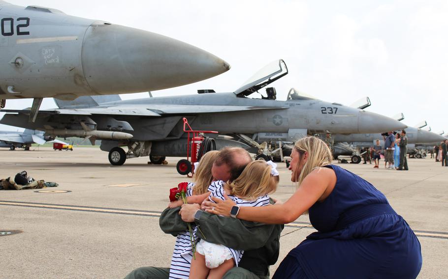 Cmdr. Jaime Moreno dropped to the ground to wrap his arms around his two daughters, 4-year-old Anna and 2-year-old Olivia, as his wife and their mother Lynn Moreno kneeled at their sides. Moreno, an F-18 pilot with Strike Fighter Squadron 83 “Rampagers” returned Friday, July 12, 2024, from a nearly nine-month deployment with the USS Dwight D. Eisenhower Carrier Strike Group. 