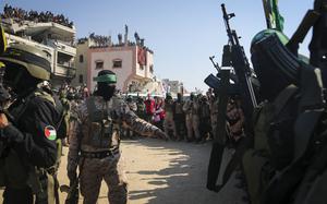 Gun-weilding Troops secure space in the street.