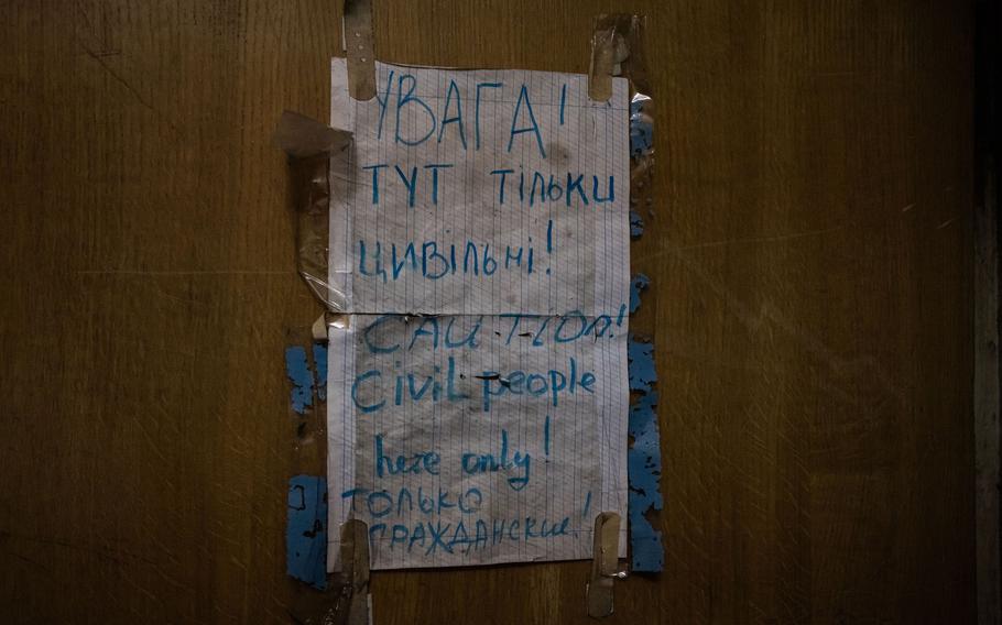 Sign indicating civilians behind door