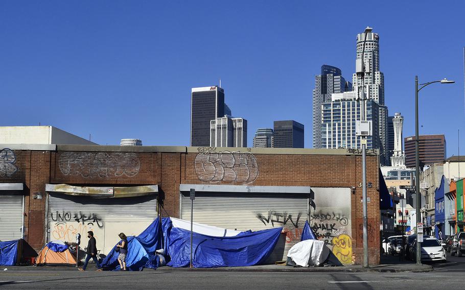 Tents housing the homeless line up in front of closed storefronts near downtown Los Angeles, California on Feb. 16, 2022.