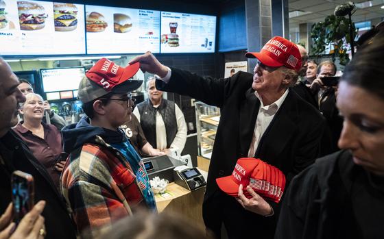 Former president Donald Trump hands out MAGA hats at McDonald’s last year in East Palestine, Ohio. His campaign is responsible for virtually all the $35,900 federal candidates have spent at the fast-food chain since January 2023 — $31,000 or about 86%. Overall, Republicans have spent about 28 times as much as Democrats at the Golden Arches, a Washington Post analysis shows.