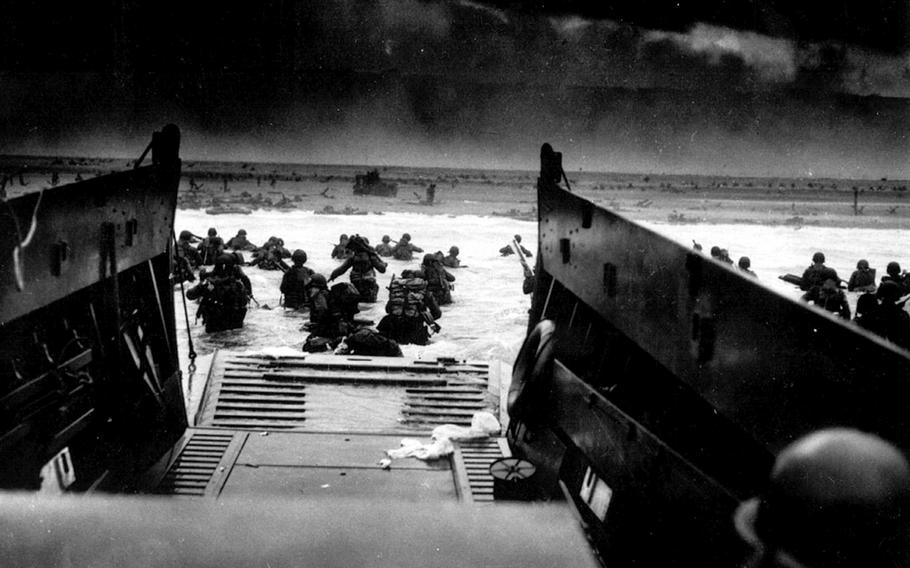 Soldiers with the U.S. Army 1st Infantry Division disembark from a Coast Guard landing craft while under machine gun fire on June 6, 1944, on Omaha Beach in Normandy, France. Omaha Beach was the most heavily defended of the beaches in Normandy.