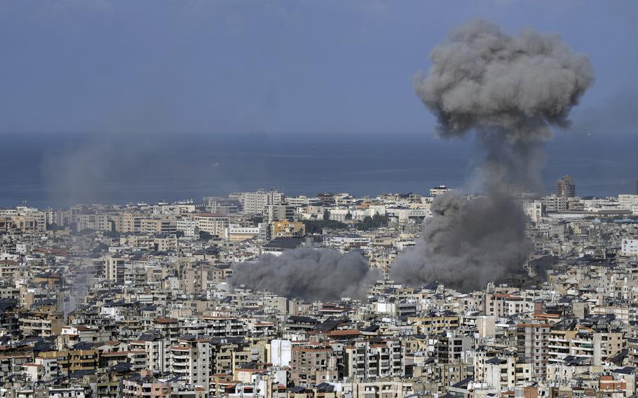 An expanse of the Beirut suburb of Dahiyeh is seen with a large plume of smoke rising above it, Nov. 16, 2024. 