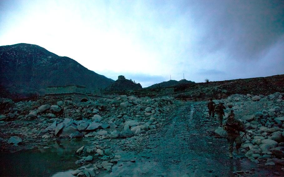 Soldiers of 1st Platoon, Company B, 2nd Battalion, 27th Infantry Regiment, cross a wadi in Asmar district