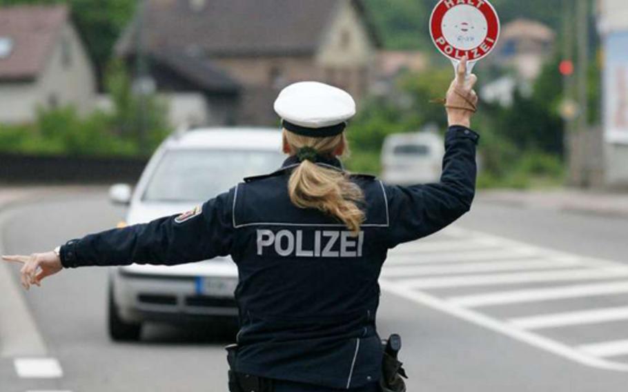 A police officer monitors traffic speed on a German highway. Recent speed checks on Autobahns 6 and 8, as well as Federal Routes B10 and B270, resulted in over 1,300 violations, with one driver clocked at 196 kph in a 100 kph zone.