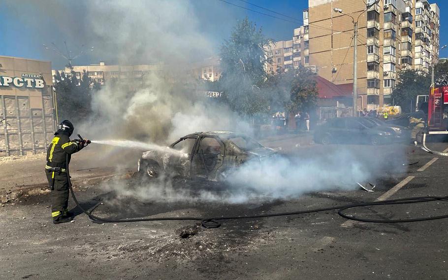 This photo released by Belgorod regional governor Vyacheslav Gladkov’s Telegram channel on Sunday, Sept. 1, 2024, firefighters extinguish a burning car in the courtyard of an apartment building after a missile attack by the Armed Forces of Ukraine on the city of Belgorod and the Belgorod region of Russia.