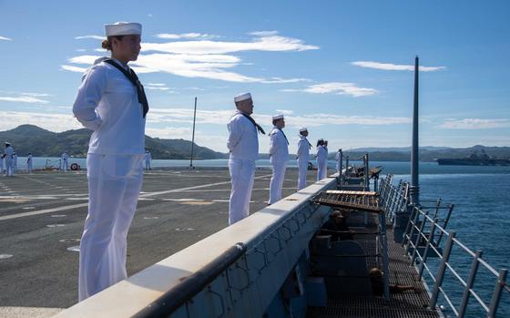 Sailors man the rails as the amphibious transport dock ship USS San Diego arrives at Sasebo Naval Base, Japan, its new homeport, Thursday, Sept. 19, 2024.