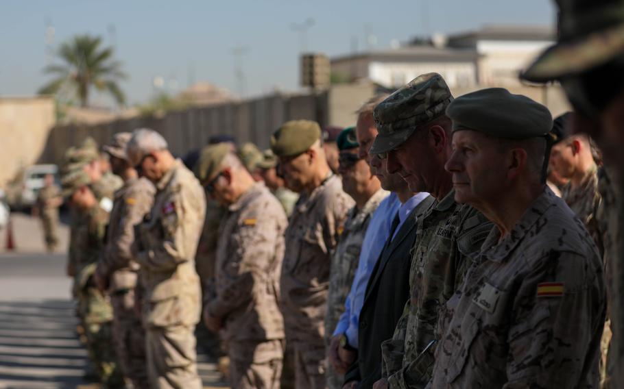 Members of the Coalition pray during a September 11th Memorial Ceremony in Baghdad, Iraq, Sept. 11, 2023. Both Coalition members and U.S. Service Members were present to reflect and remember the lives lost 22 years ago.