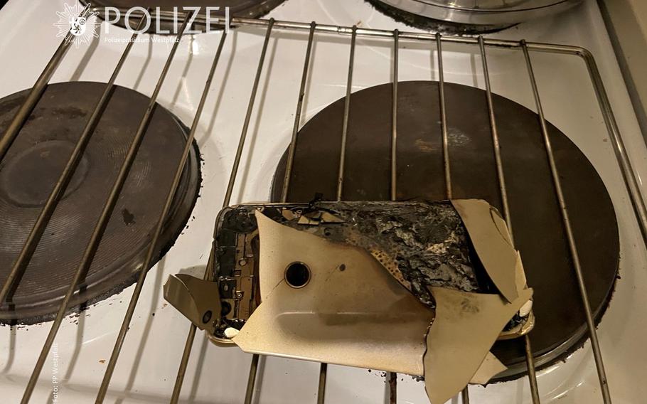A burnt smartphone sits on a stove in Kaiserslautern after police were called out Tuesday night because of smoke coming out of an apartment.