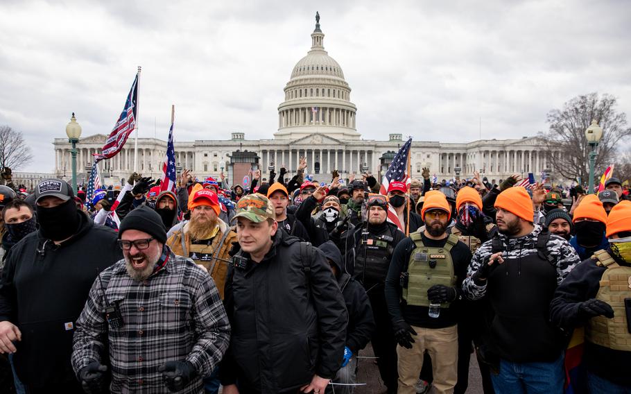 Wearing their group’s signature orange hats, members of the Proud Boys gather near the U.S. Capitol on Jan. 6, 2021. 