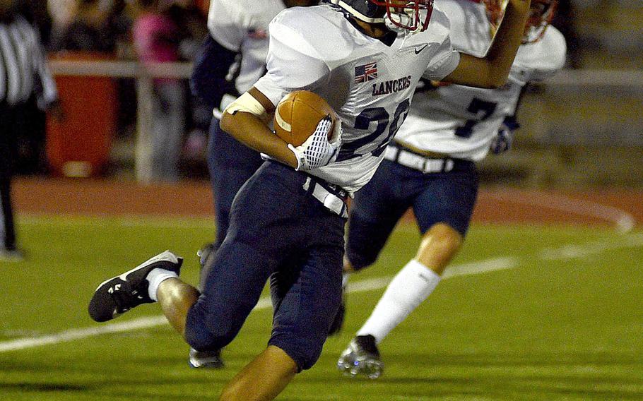 Connor Martin runs with the football.