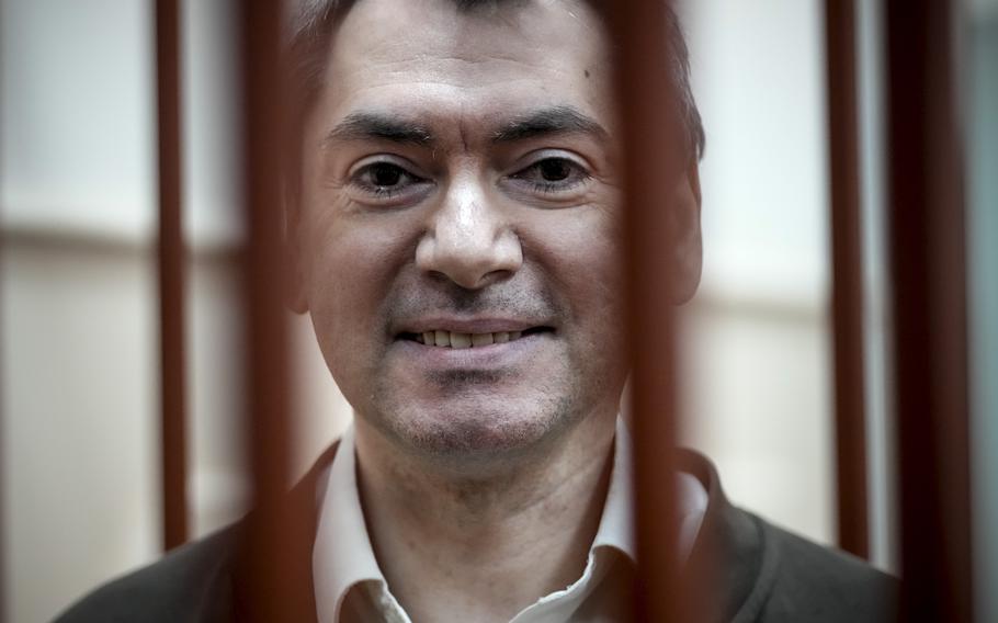 The co-chair of Russia’s leading independent election monitoring group Golos in a cage in a courtroom in Moscow, Oct. 9, 2024. 