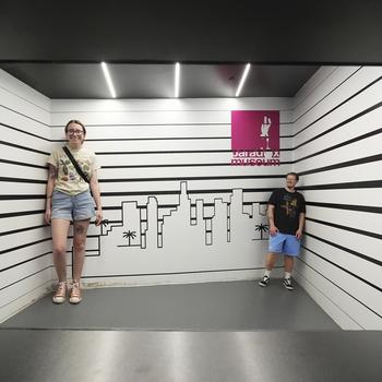 People inside the Ames Room at the Paradox Museum Miami. 