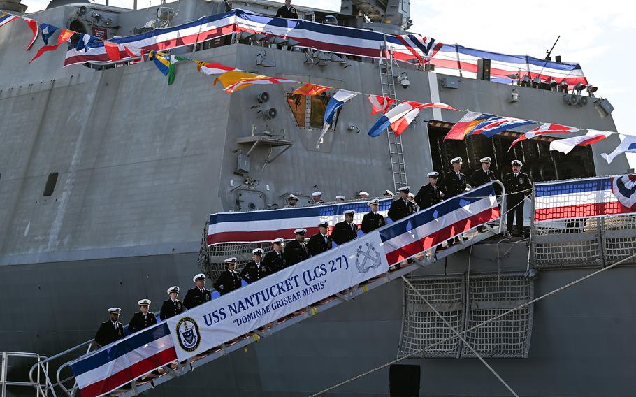 The crew of the USS Nantucket, a Freedom-variant littoral combat ship, stand by during its commissioning ceremony in Boston, Nov. 16, 2024. 