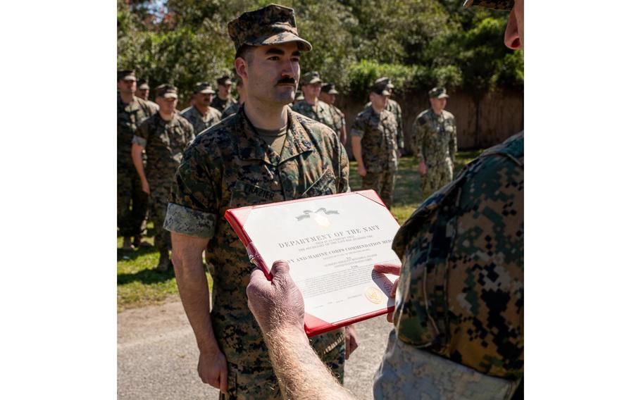 U.S. Marine Corps Gunnery Sgt. Benjamin Frazier, an intel instructor with Marine Corps Detachment Dam Neck, Va., receives the Navy and Marine Corps Commendation Medal on Thursday, March 21, 2024, at Naval Air Station Dam Neck, Va. In May 2022, Frazier helped save the life of a fellow Marine. 