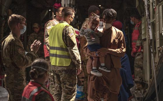 Afghan refugees step off a C-130J Super Hercules on Sept. 6, 2021, at Dyess Air Force Base, Texas, during Operation Allies Welcome. Over 1,600 Afghans previously cleared to enter the U.S. have had their flights canceled as President Donald Trump signed an executive order preventing all refugees from entering the country for 90 days.