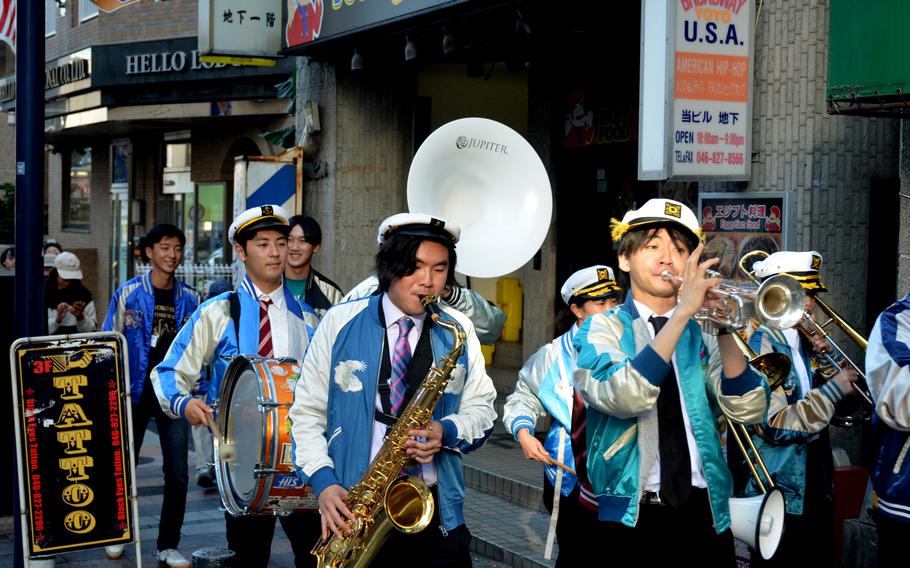 Members of Waseda University's jazz club march down the Honch during the annual jazz and rock festival in Yokosuka, Japan, Nov. 4, 2024. 