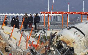 FILE - Experts from the U.S. National Transportation Safety Board (NTSB) and joint investigation team between the U.S. and South Korea check the site of a plane crash at Muan International Airport in Muan, South Korea, Dec. 31, 2024. (Son Hyung-joo/Yonhap via AP, File)