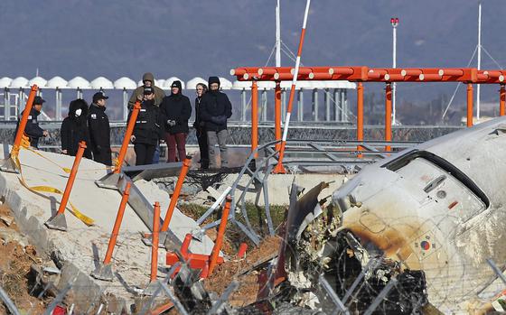 FILE - Experts from the U.S. National Transportation Safety Board (NTSB) and joint investigation team between the U.S. and South Korea check the site of a plane crash at Muan International Airport in Muan, South Korea, Dec. 31, 2024. (Son Hyung-joo/Yonhap via AP, File)