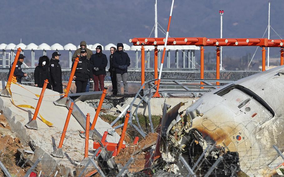 Experts examine the site of a plane crash.