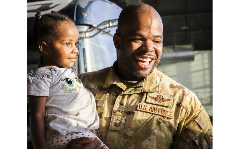 Airman carries a young girl