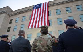 A flag drapes down from the Pentagon to mark the 23rd anniversary of the Sept. 11, 2001, terrorist attacks