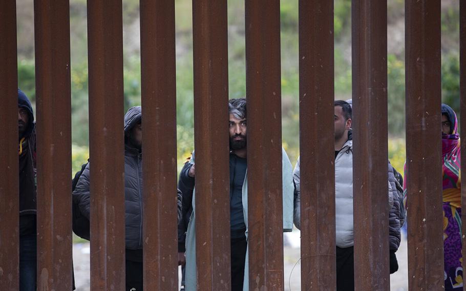 Obaidullah, 33, of Afghanistan, center, worked as a translator for the U.S. Army for five years and is now one of more than hundred migrants who have been apprehended by U.S. Border Patrol. He said on Wednesday, April 12, 2023, in San Diego ,that some had been stuck in-between the U.S.-Mexico border walls for up to seven days . 