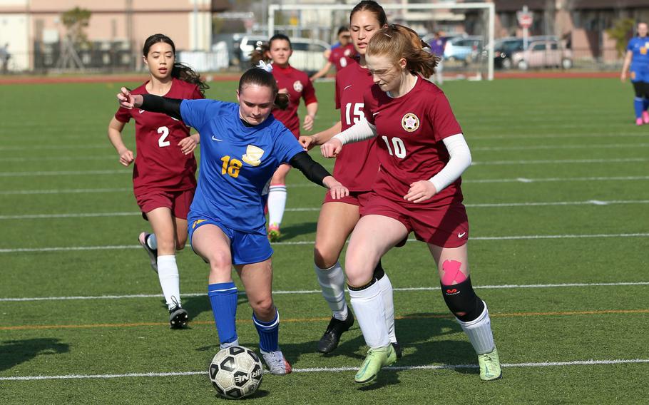 Yokota's Hailey Riddels and Perry's McKenzie Mitchell chase the ball during Saturday's DODEA-Japan girls soccere match. The Panthers won 6-3.