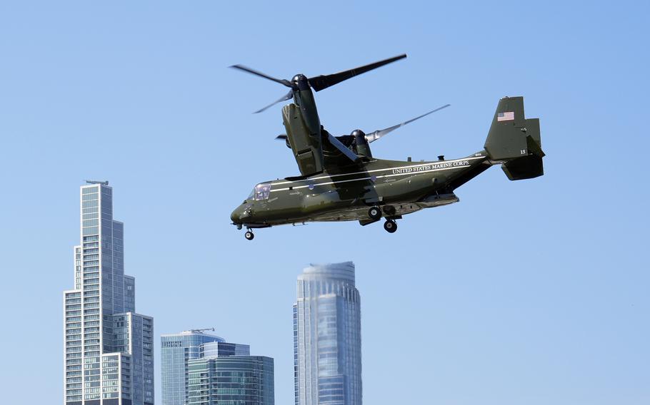 An Osprey flies along the Chicago skyline.