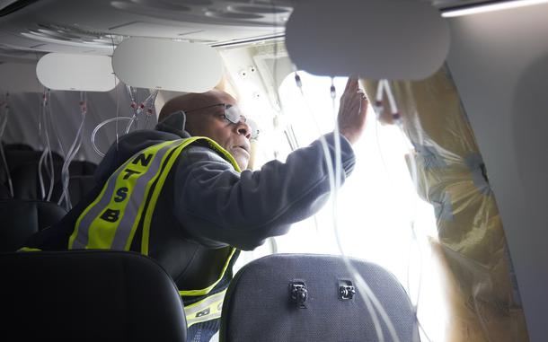 A man inspecting an airplane.