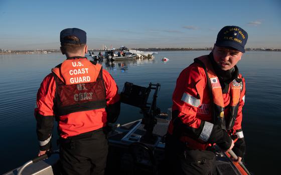 U.S. Coast Guard members respond to an aircraft collision on the Potomac River.