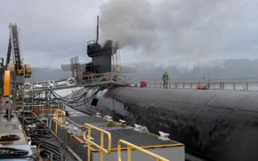 Photo of Ohio-class ballistic missile submarine USS Henry M. Jackson (SSBN 730) docked on Naval Base Kitsap’s Delta Pier, Dec. 28, 2023. Trident Refit Facility, Bangor’s (TRFB) core mission is repairing, incrementally overhauling, and modernizing the Pacific Fleet’s ballistic missile submarine force. (U.S. Navy Photo by Mass Communication Specialist 2nd Class Adora Okafor)