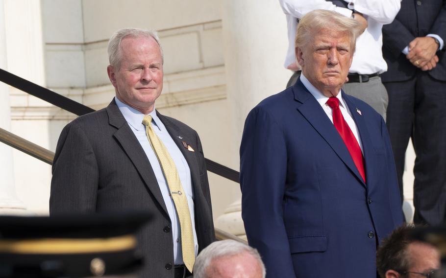 Former President Donald Trump, right, and deputy chief of staff for Arlington National Cemetery Bob Quackenbush watch the changing of the guard at the Tomb of the Unknown Solider on Aug. 26, 2024.