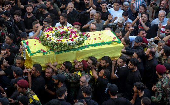 Hezbollah supporters carry the coffin of a victim during the funeral procession of four victims — including a child — who were killed in electronic pagers explosion, during their funeral procession in Beirut, Lebanon, on Sept. 18, 2024. Thousands of people were wounded in the cyberattack and at least 39 were killed. Several high-ranking representatives and members of the Radwan Force, an elite unit within the group, are said to be among the victims. (Marwan Naamani/dpa via Zuma Press/TNS)