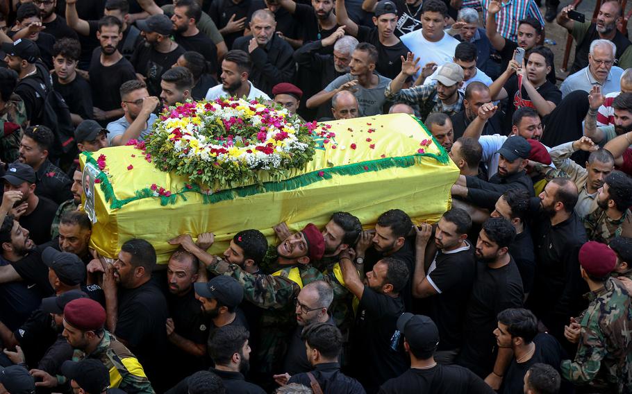 Hezbollah supporters carry the coffin of a victim of a pager explosion.