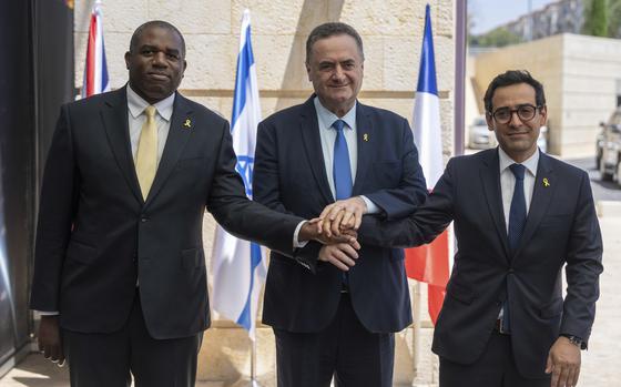 Britain's Foreign Secretary David Lammy, left, and French Foreign Minister Stéphane Séjourné, right, are welcomed by Israeli Minister of Foreign Affairs Israel Katz, at their meeting in Jerusalem, Friday, Aug. 16, 2024. (AP Photo/Ohad Zwigenberg)