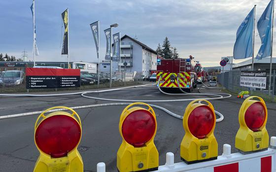 An Air Force fire truck is lined up ahead in front of a cordon in Landstuhl, Germany, following an early morning industrial fire on Dec. 5, 2024. 