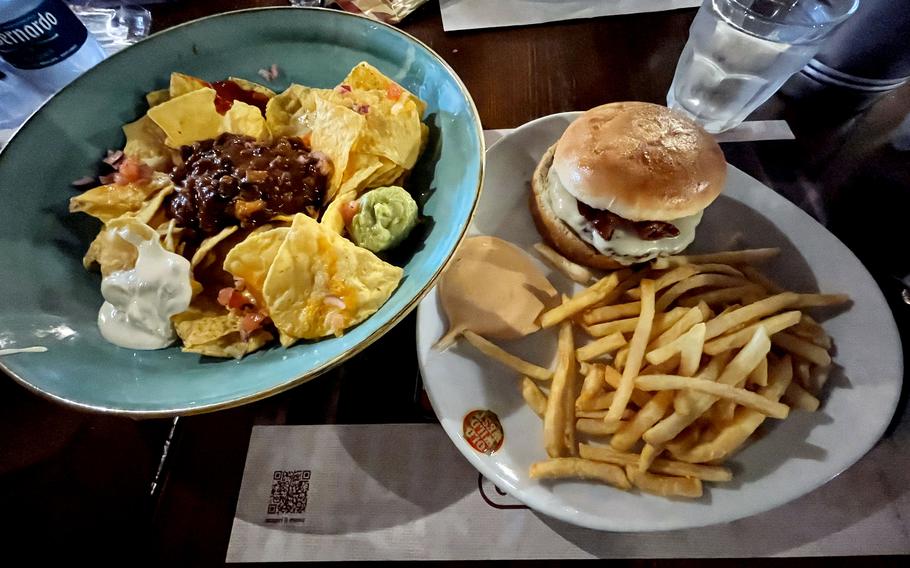 Mexican nachos served next to the Dakota burger with fries at Old Wild West in Fiume Veneto, Pordenone, Italy, on May 14th, 2024. 