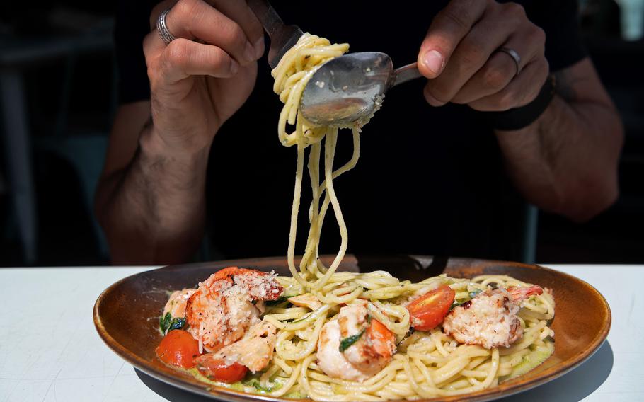 The spaghetti with salmon and herb cream sauce at Der Nudelmacher in Neustadt, Germany, can be ordered with extra prawns. 